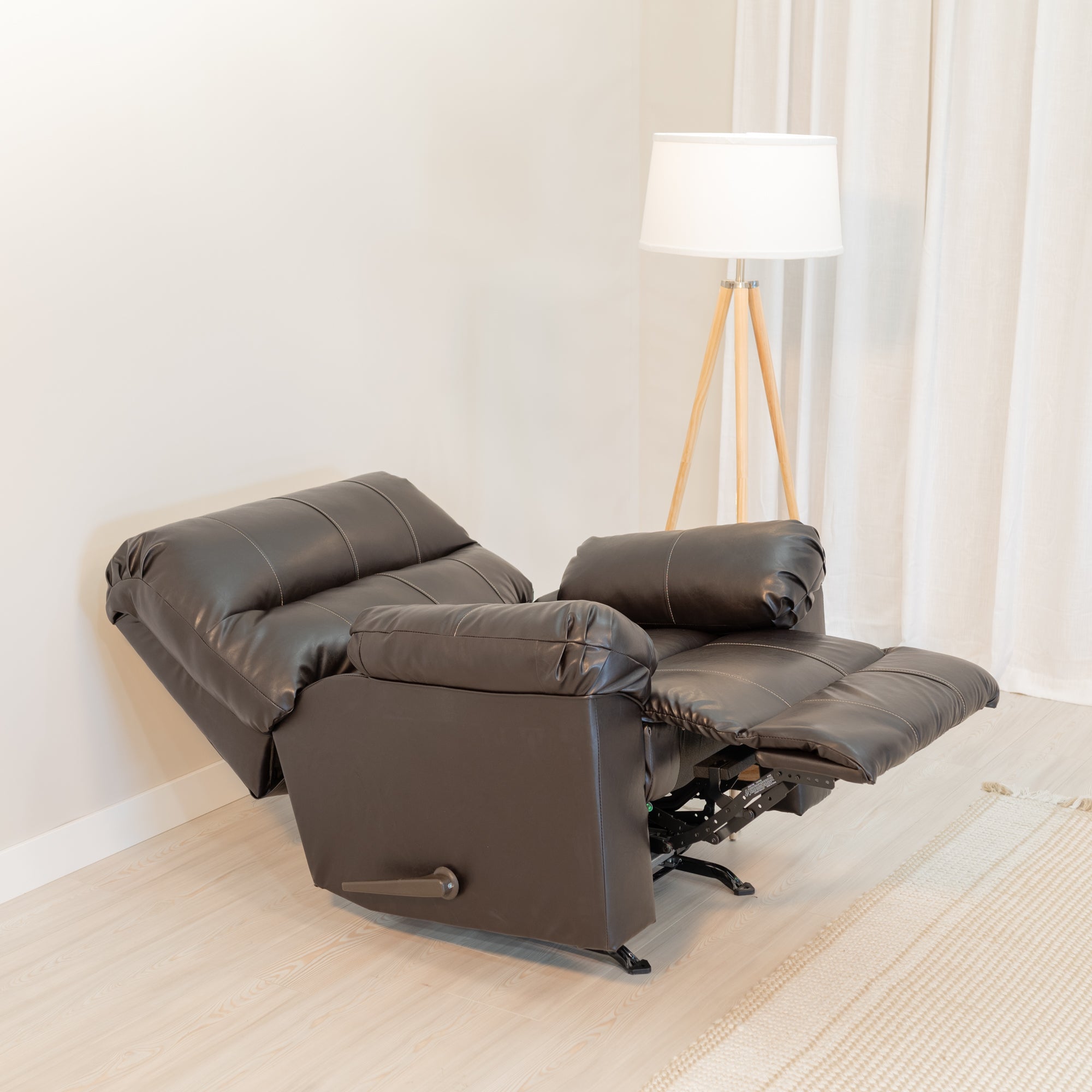 An angled view of the recliner showing it fully reclined with an extending foot rest.