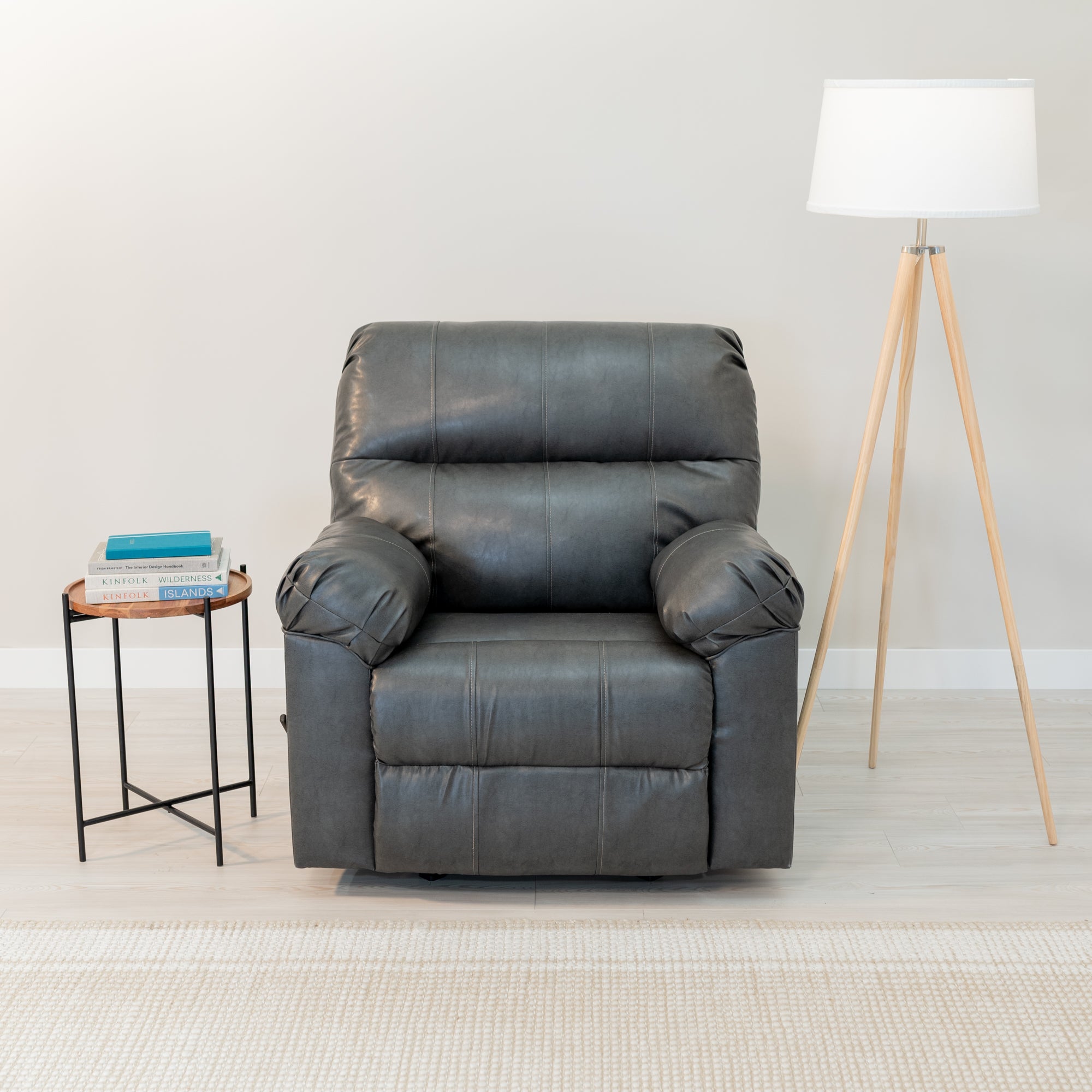 An overstuffed recliner sits in a comfortable looking living room. it is surrounded by  a side table and lamp.