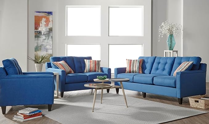 A royal blue loveseat sofa and chair sit in a living room